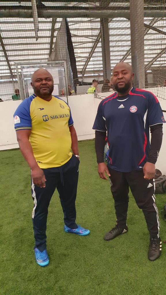 Xavier, Secretary General of Amical FC on the right with Mr Johnson, a member of the team.